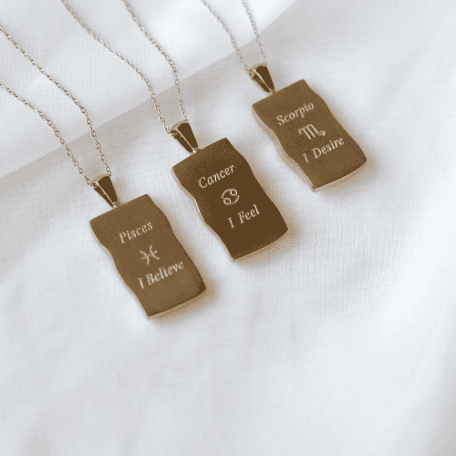 Image shows the back of zodiac necklaces in gold in Pisces, Cancer and Scorpio variants