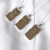 Image shows the back of zodiac necklaces in silver in Aries, Sagittarius and Leo